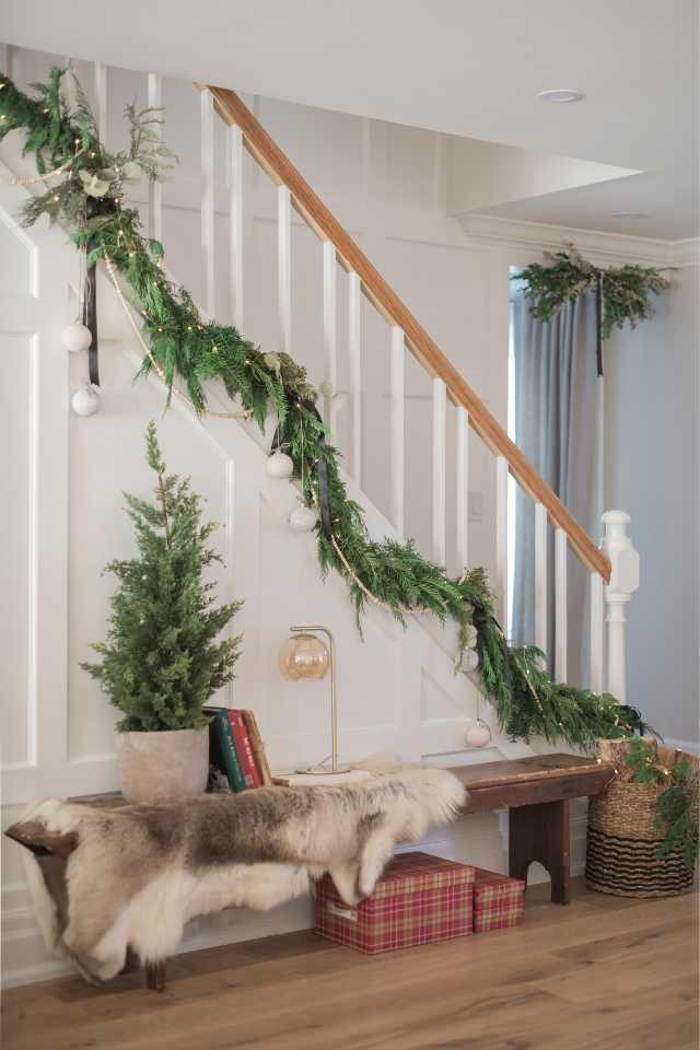 designer holiday home with stairway garland and vintage details